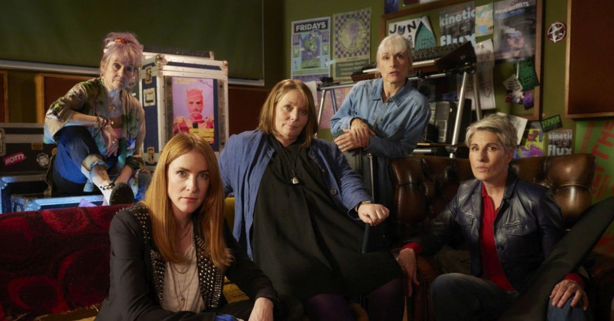 riot women cast on a couch